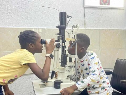 Children learning to use an Ophthalmoscope